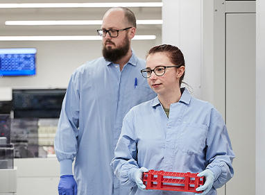 Female and male Lifeblood laboratory technicians walking together