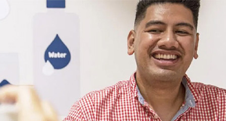a man seated and smiling