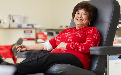 A woman sitting in a donor chair 