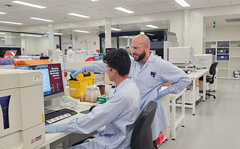 Two scientists working on a computer 