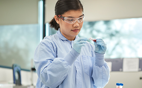 Researcher looking at a blood sample in the lab