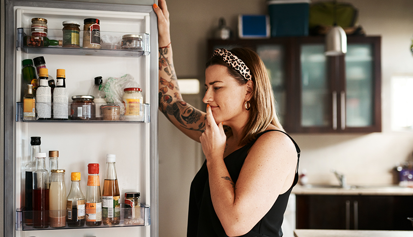 Woman looking in fridge