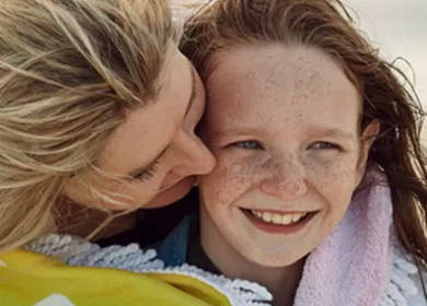 Mum and daughter Eva embracing on the beach