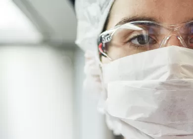 closeup of a technician holding a container