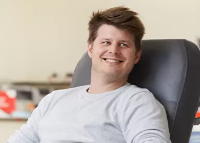 Male donor sitting in a chair while giving blood