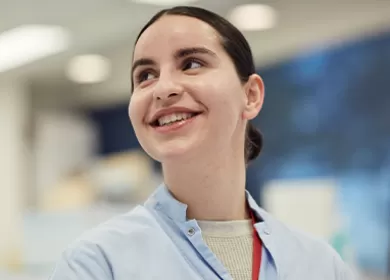 a scientist is smiling and looking up to her right