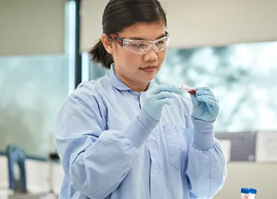 Researcher looking at a blood sample in the lab