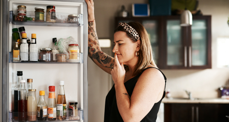 Woman looking in fridge