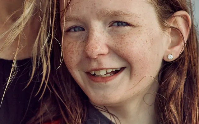 a girl smiling at the camera