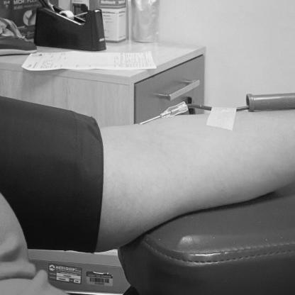 person donating with a needle in their arm