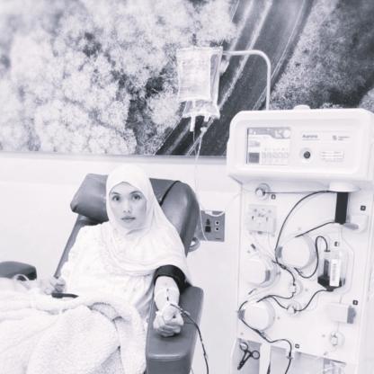 A woman with a hijab sitting on a donation couch during her donation