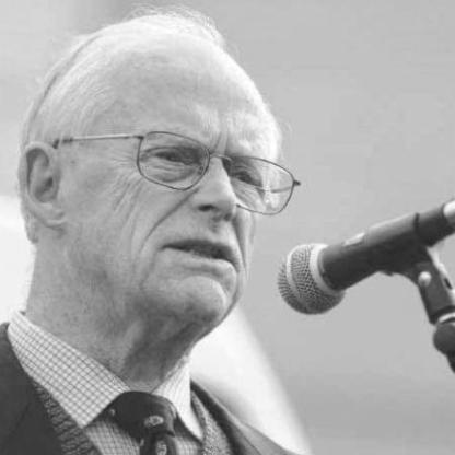 man speaking in front of a microphone