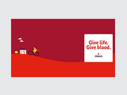 illustration of a donor centre and donor riding a bike with lifeblood logo and words 'give life. give blood'