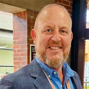 profile photo of richard wearing a grey suit jacket and blue shirt