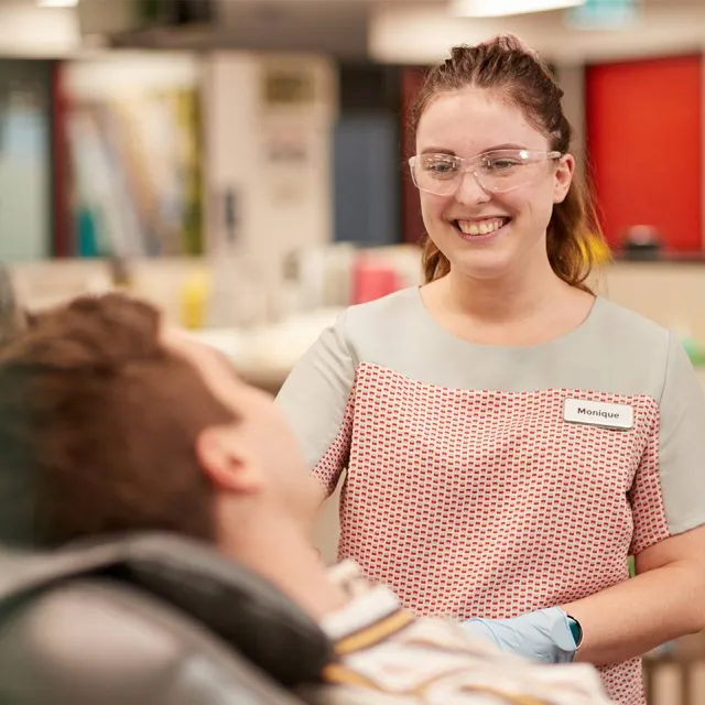 a nurse next to someone giving a donation