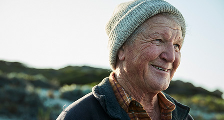 a man wearing a beanie and smiling