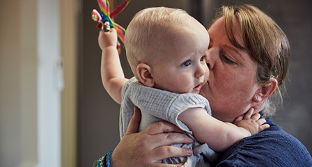 a mother holding her baby
