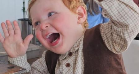 happy child with red hair pulling a funny face